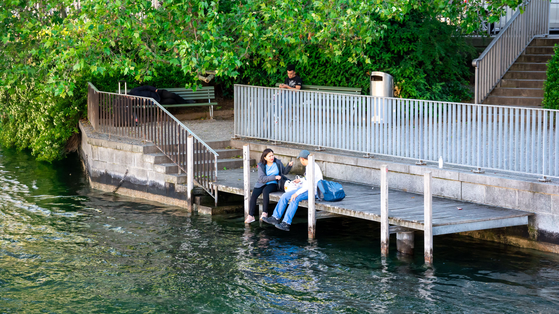 People relaxing along the waterbank